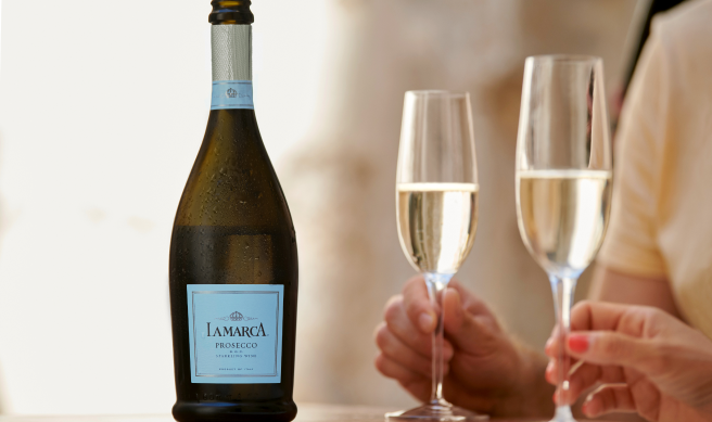 A bottle of La Marca Prosecco featuring light blue label with a matching deep blue foil top.